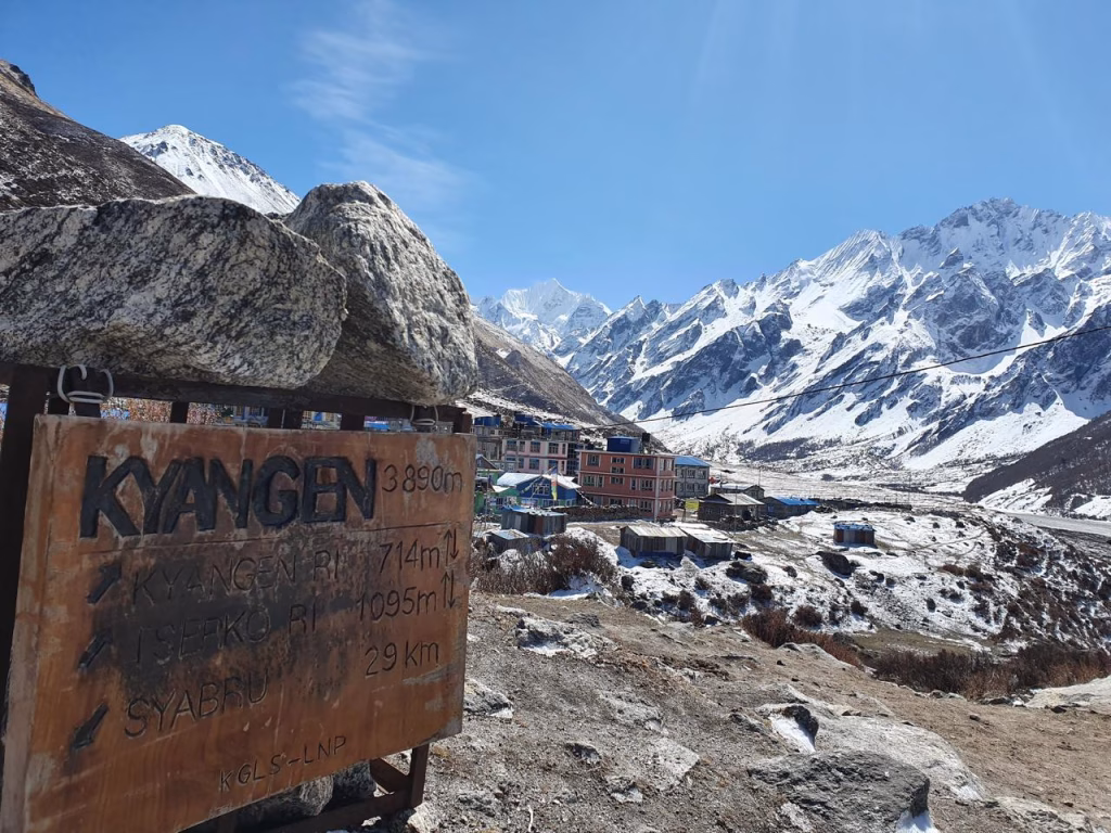 a sign showing kyanjin and mountains in the back
