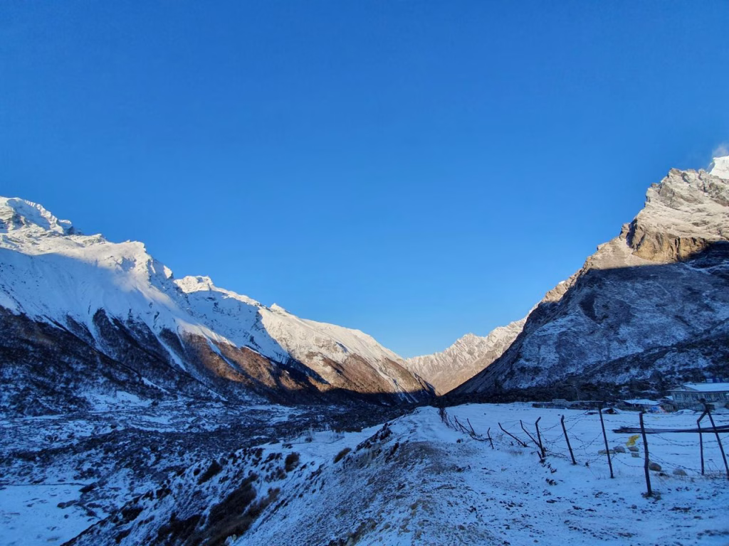sun reflected on mountains with snow covered landscapes