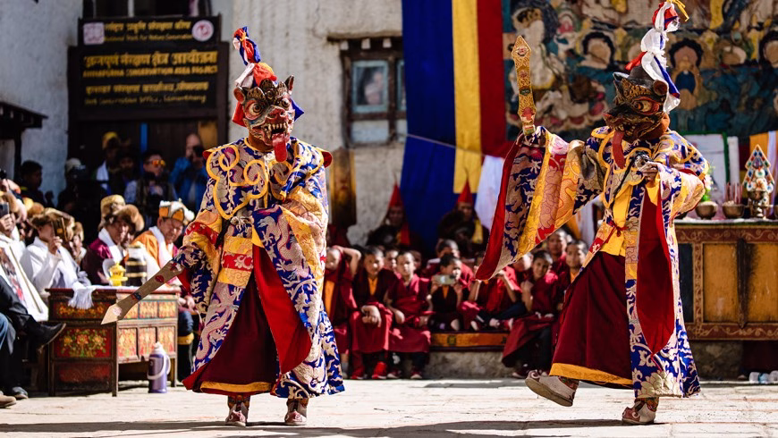 Masked dancers performing at a festival.
